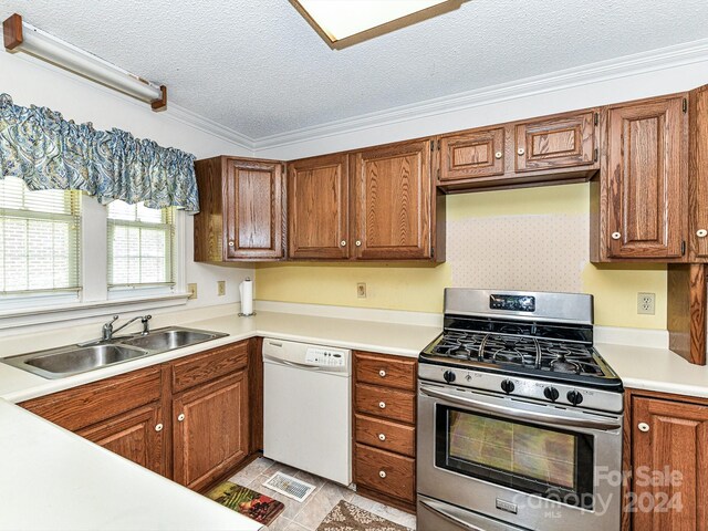 kitchen with ornamental molding, sink, a textured ceiling, dishwasher, and gas stove