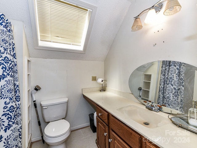 bathroom with vaulted ceiling, vanity, toilet, and tile patterned floors