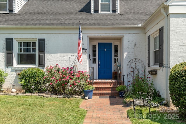 doorway to property with a lawn