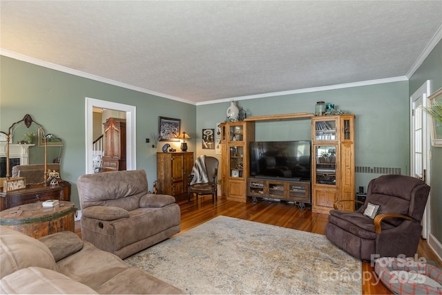 living room featuring hardwood / wood-style flooring, radiator heating unit, crown molding, and a textured ceiling