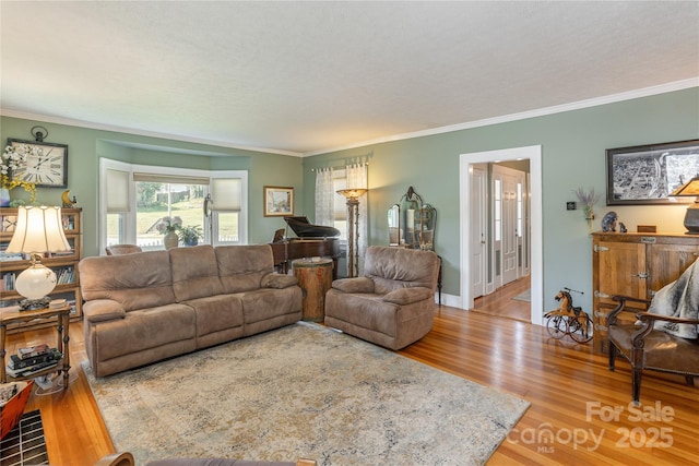 living room featuring crown molding and hardwood / wood-style floors