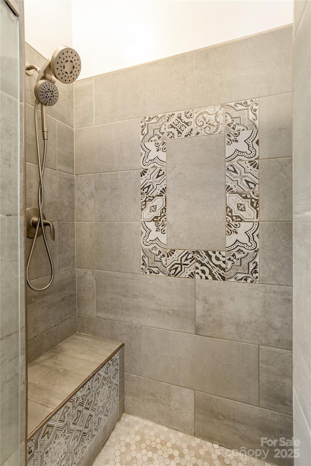 bathroom with a tile shower