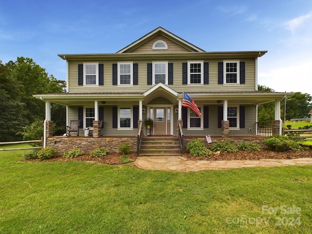 view of front facade with a front lawn and a porch