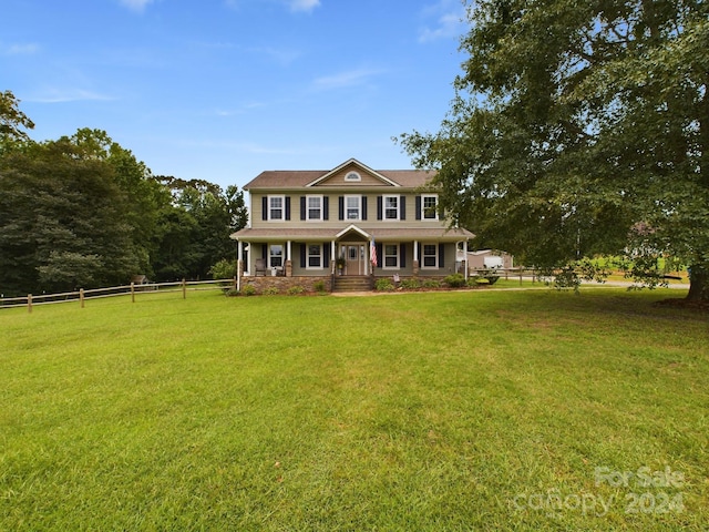 colonial inspired home featuring a front lawn and covered porch