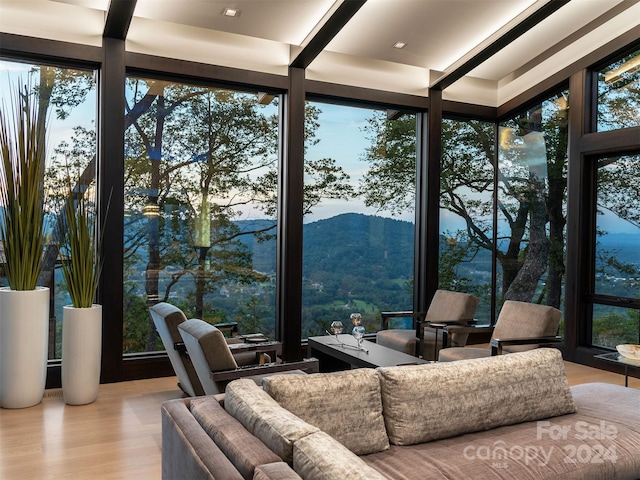 sunroom with a wealth of natural light and a mountain view