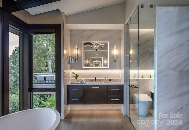 bathroom featuring tile patterned flooring, backsplash, lofted ceiling, tile walls, and vanity