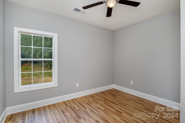 empty room with hardwood / wood-style floors and ceiling fan