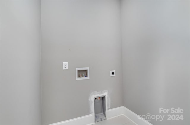 washroom with hookup for a washing machine, light tile patterned floors, and electric dryer hookup