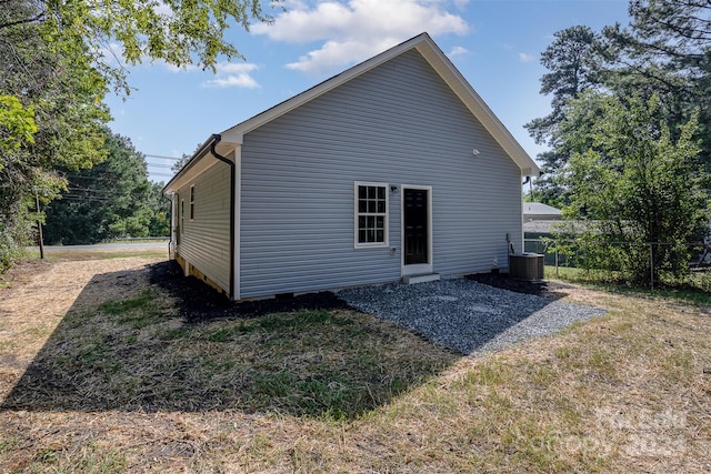 rear view of property with central AC