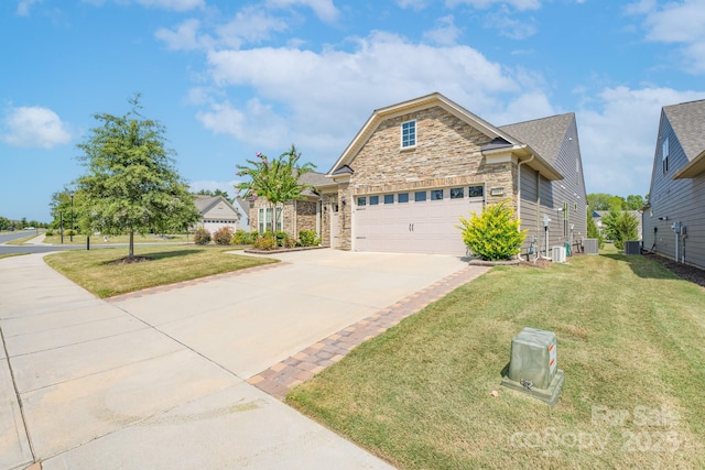 view of front of home featuring cooling unit, a garage, and a front lawn