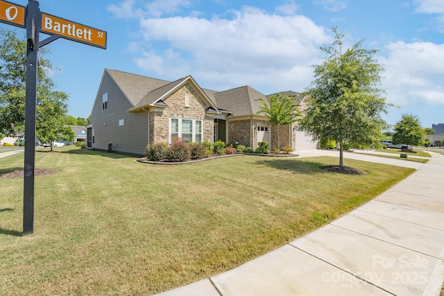 view of front of house with a garage and a front lawn