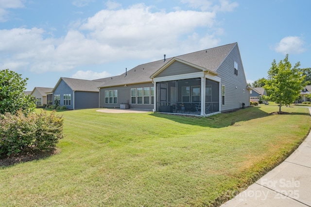 back of house with a lawn, a patio area, and a sunroom