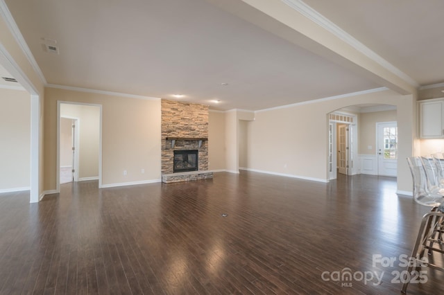 unfurnished living room featuring a fireplace, dark hardwood / wood-style floors, and ornamental molding