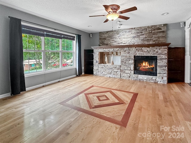 unfurnished living room featuring hardwood / wood-style flooring and a textured ceiling