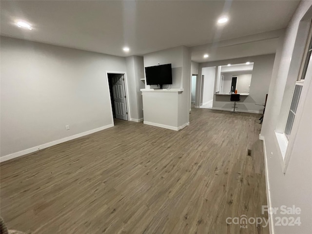 unfurnished living room featuring hardwood / wood-style flooring