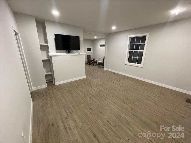 unfurnished living room featuring dark hardwood / wood-style floors