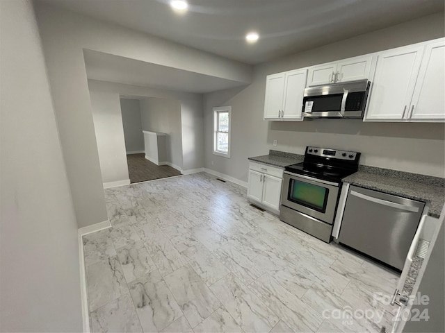 kitchen with white cabinetry and appliances with stainless steel finishes