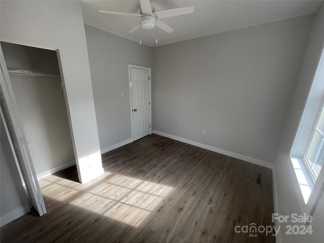 unfurnished bedroom with wood-type flooring, a closet, and ceiling fan