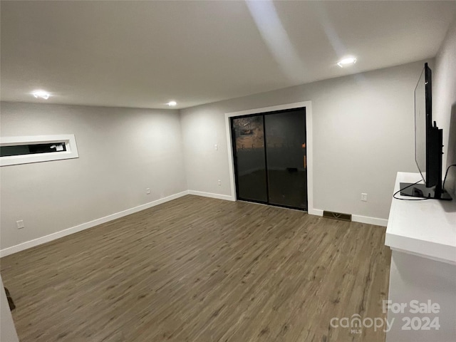 unfurnished living room with dark hardwood / wood-style floors