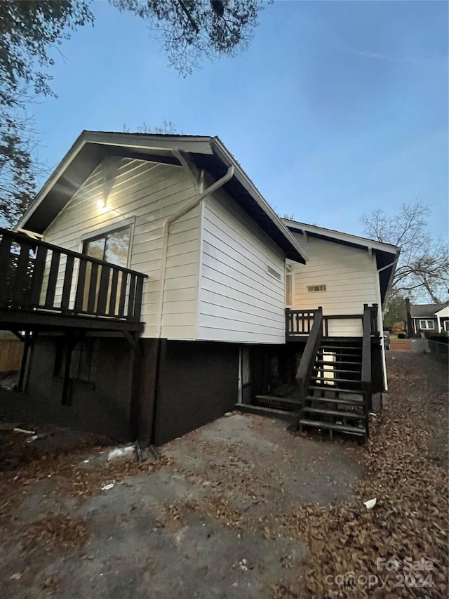 view of side of property featuring a wooden deck