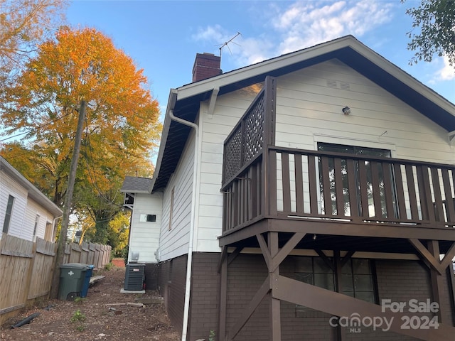 back of house featuring a balcony and central AC unit