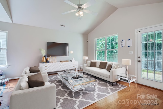 living room with high vaulted ceiling, ceiling fan, visible vents, and wood finished floors