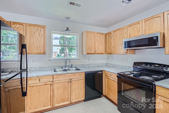 kitchen featuring visible vents, light countertops, light brown cabinetry, black appliances, and a sink