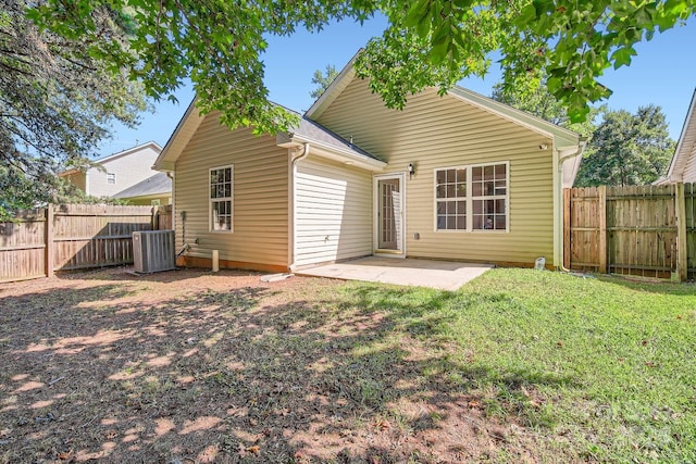 rear view of house featuring central air condition unit, a yard, a fenced backyard, and a patio