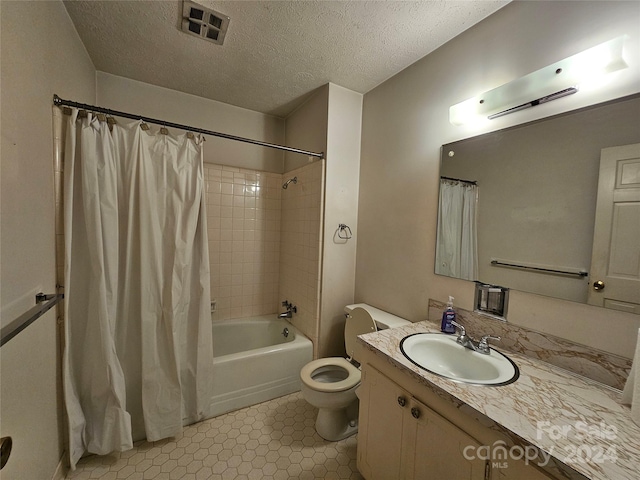 full bathroom with vanity, toilet, a textured ceiling, and shower / bath combo with shower curtain