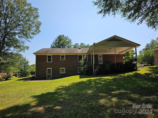 back of property with a lawn