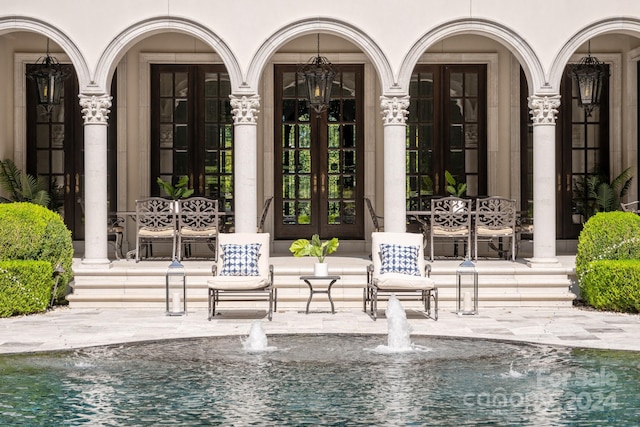 view of swimming pool featuring french doors