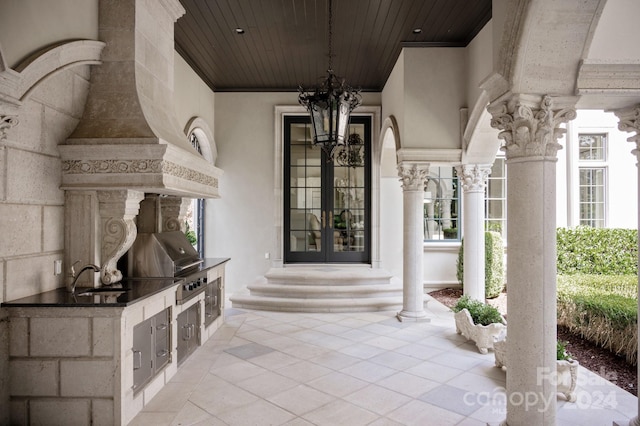 property entrance featuring an outdoor kitchen, sink, and french doors