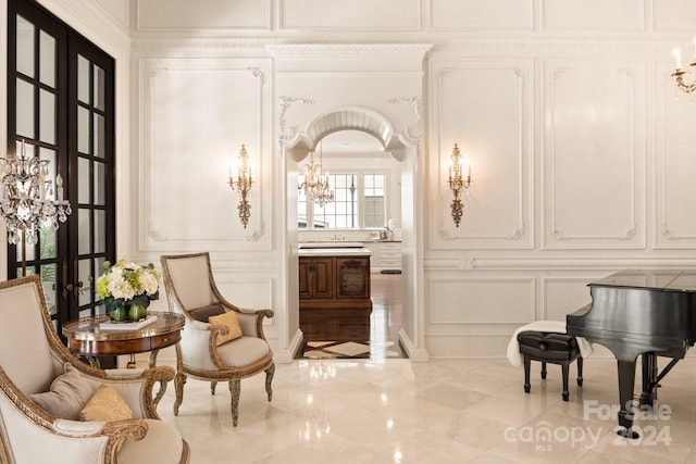 sitting room featuring a notable chandelier and french doors