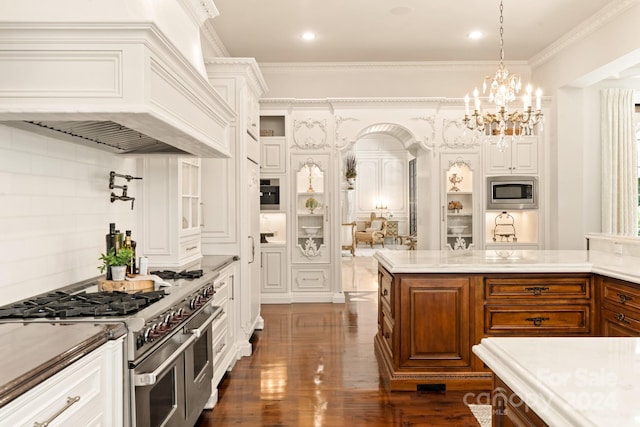 kitchen featuring pendant lighting, crown molding, stainless steel appliances, dark hardwood / wood-style floors, and custom range hood