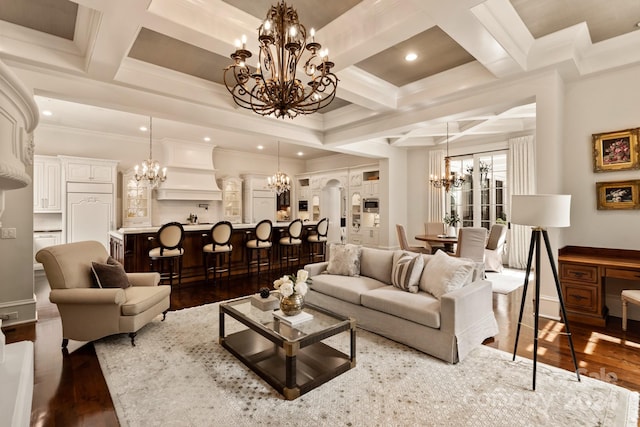 living room featuring crown molding, a chandelier, coffered ceiling, dark wood-type flooring, and beam ceiling