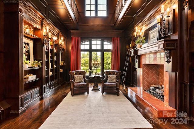 living area featuring dark wood-type flooring and wood walls