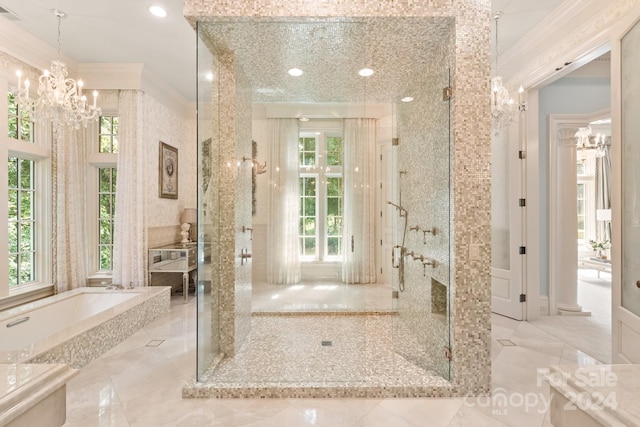 bathroom featuring a healthy amount of sunlight, a notable chandelier, and shower with separate bathtub