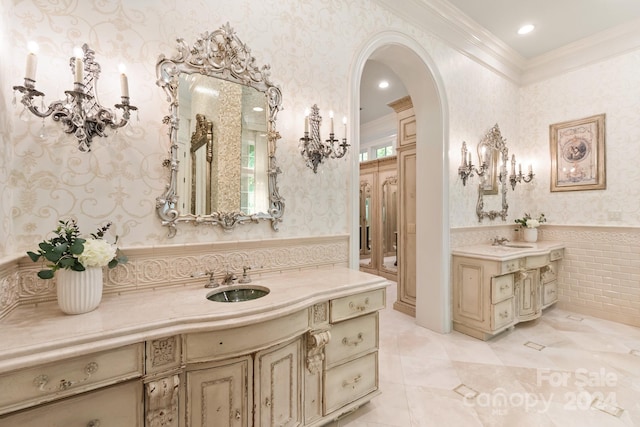 bathroom with ornamental molding and vanity