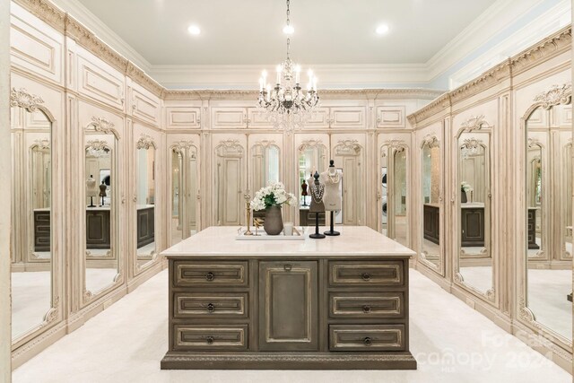 bathroom featuring vanity, a chandelier, and crown molding