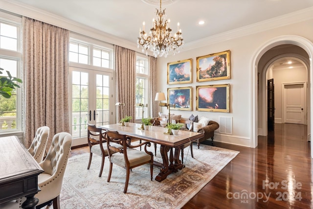 dining room with ornamental molding, wood-type flooring, and a chandelier