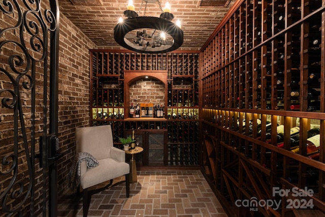 wine cellar featuring brick ceiling and brick wall