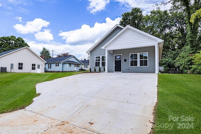 view of front of property with central air condition unit and a front lawn