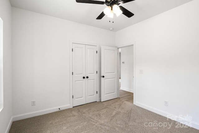 unfurnished bedroom featuring carpet floors, a closet, ceiling fan, and baseboards