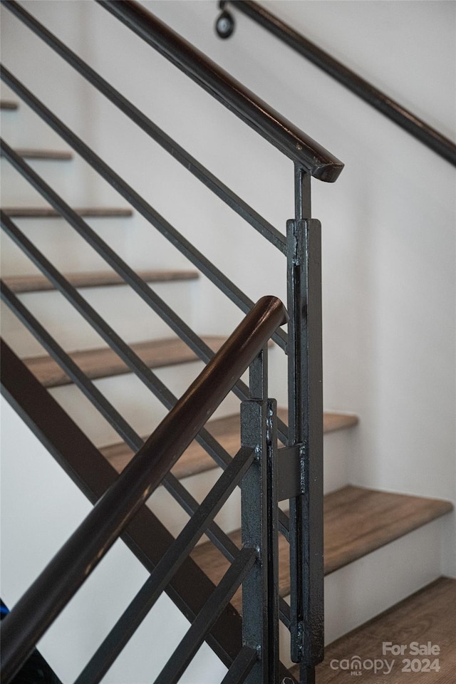 stairway with hardwood / wood-style floors
