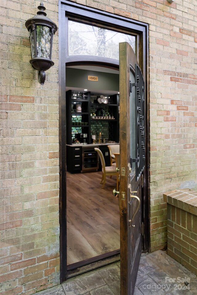 wine area featuring brick wall