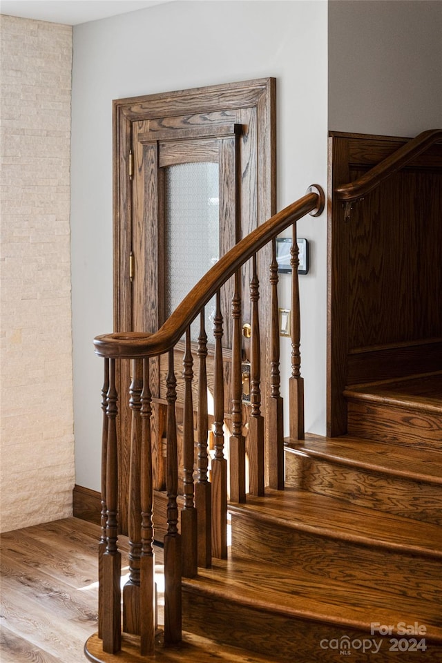 staircase featuring wood-type flooring