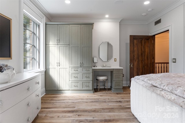 bedroom with light hardwood / wood-style floors and ornamental molding