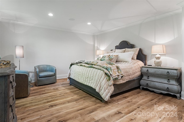 bedroom featuring hardwood / wood-style flooring and ornamental molding