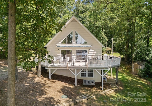 back of house with a storage unit and a deck