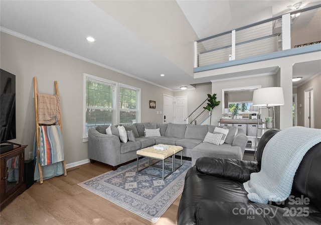 living room with light hardwood / wood-style floors and crown molding